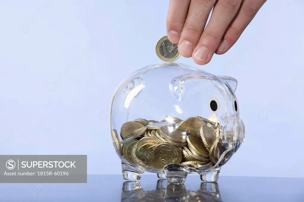 Man putting money into piggy bank