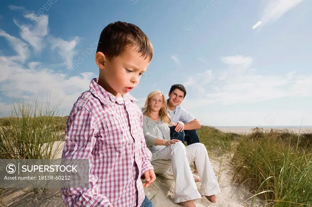 Germany, Schleswig Holstein, Amrum, Family in sand dunes