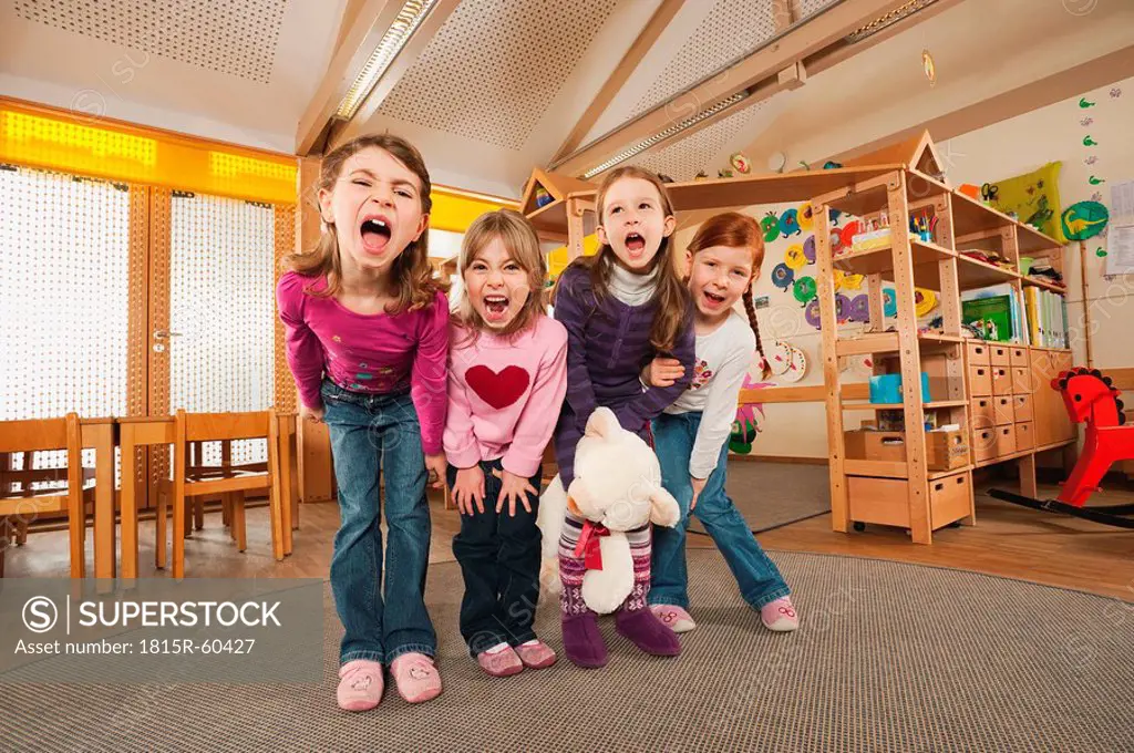 Germany, Children in nursery standing side by side screaming, portrait