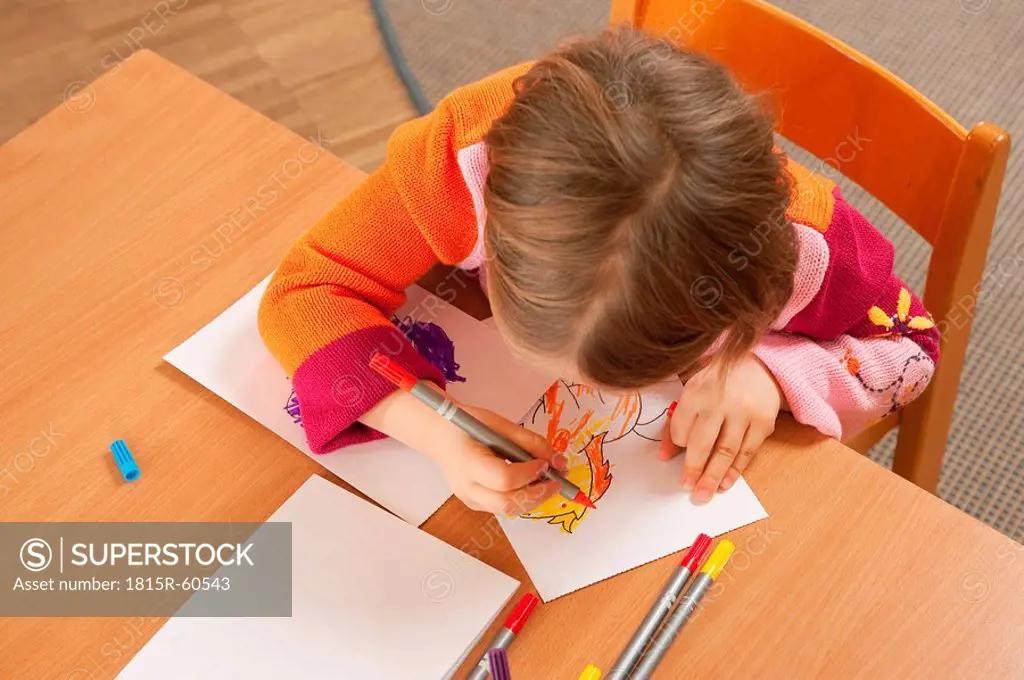 Germany, Girl 3_4 in nursery drawing a picture, elevated view