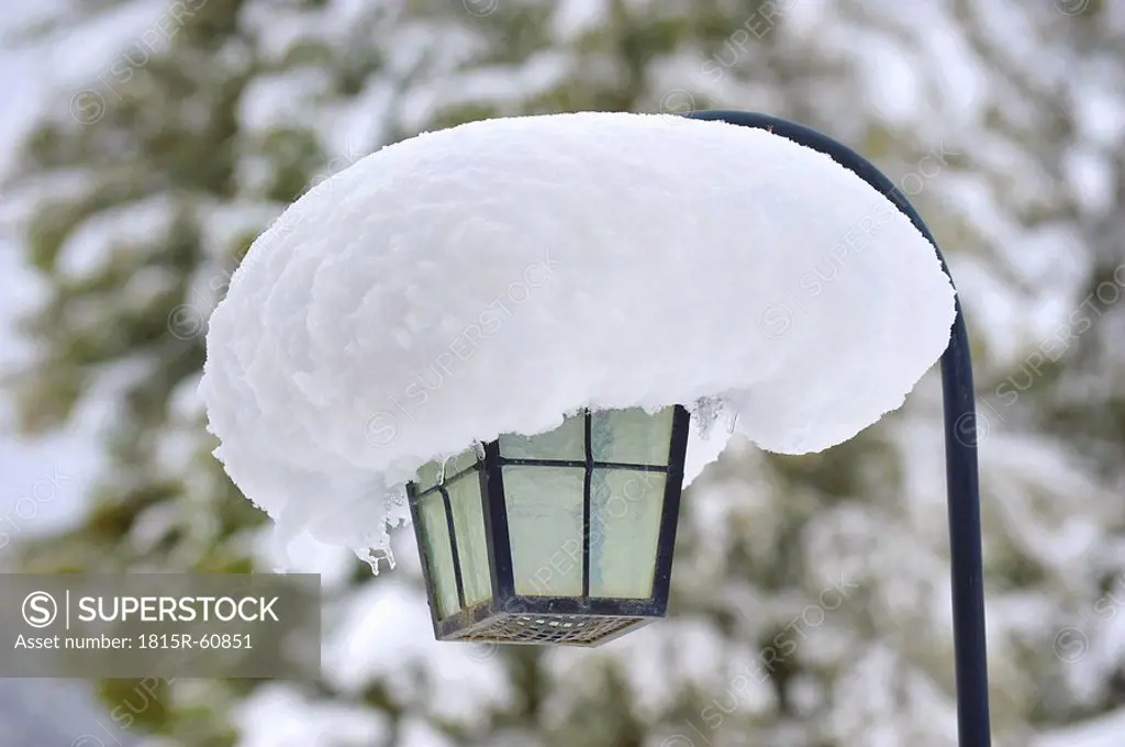 Germany, Snowcapped street lamp, close_up