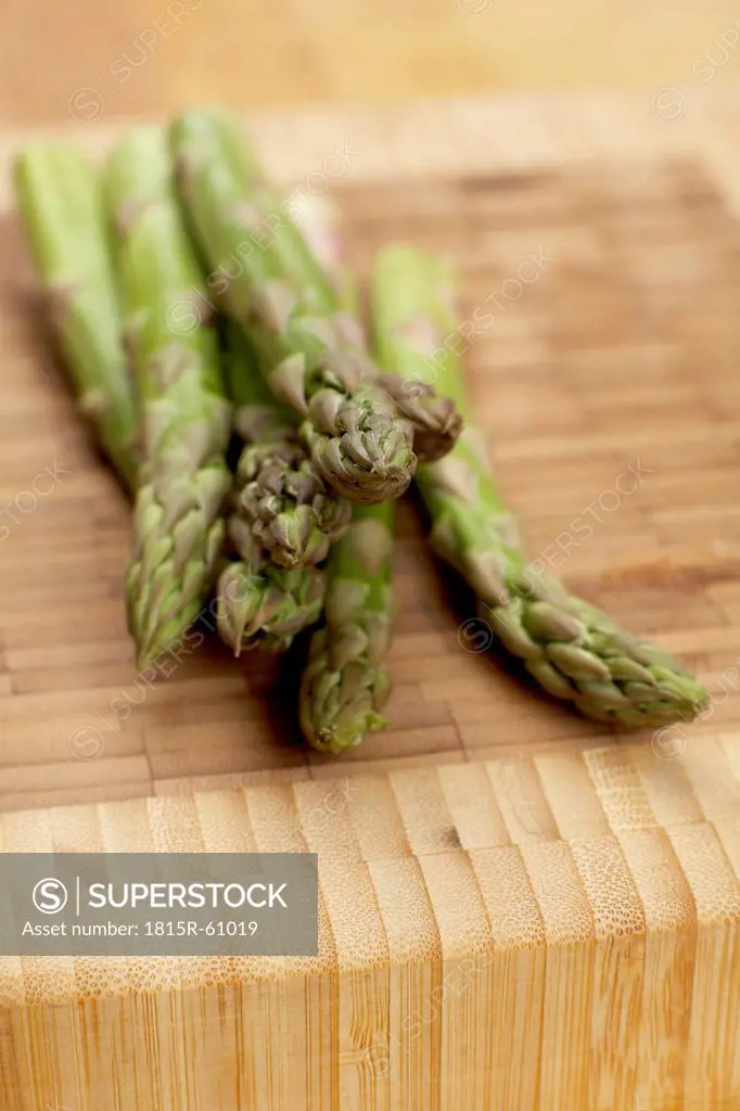 Green asparagus on wooden board
