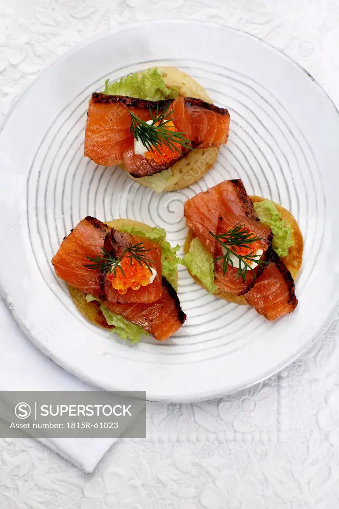 Appetiser, Canapes with salmon, dill and trout caviar on plate, elevated view