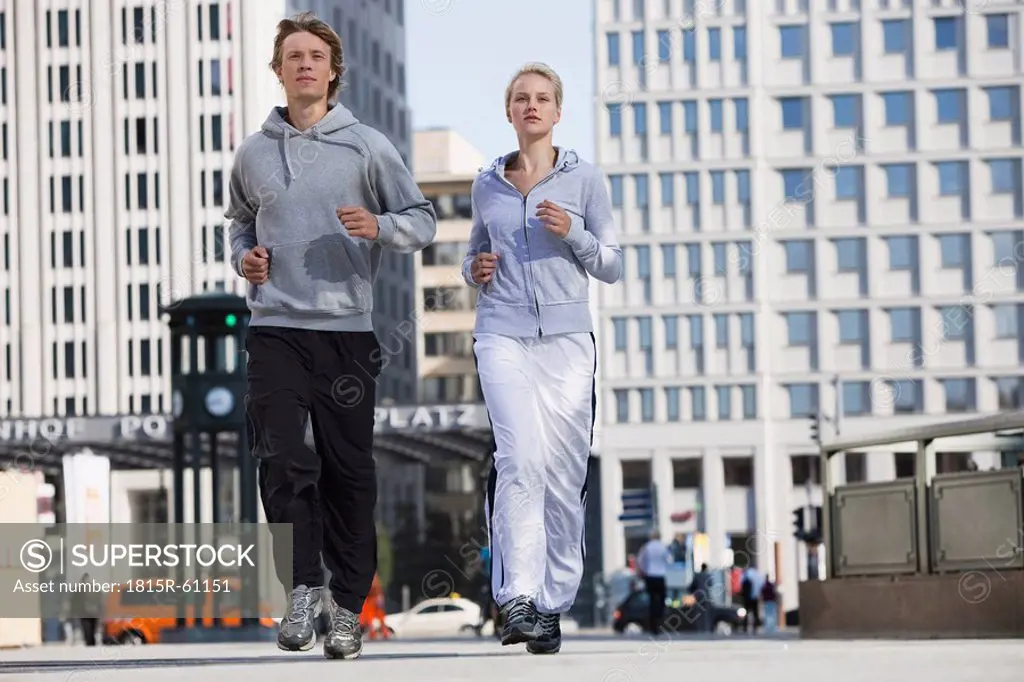 Germany, Berlin, Young couple jogging together