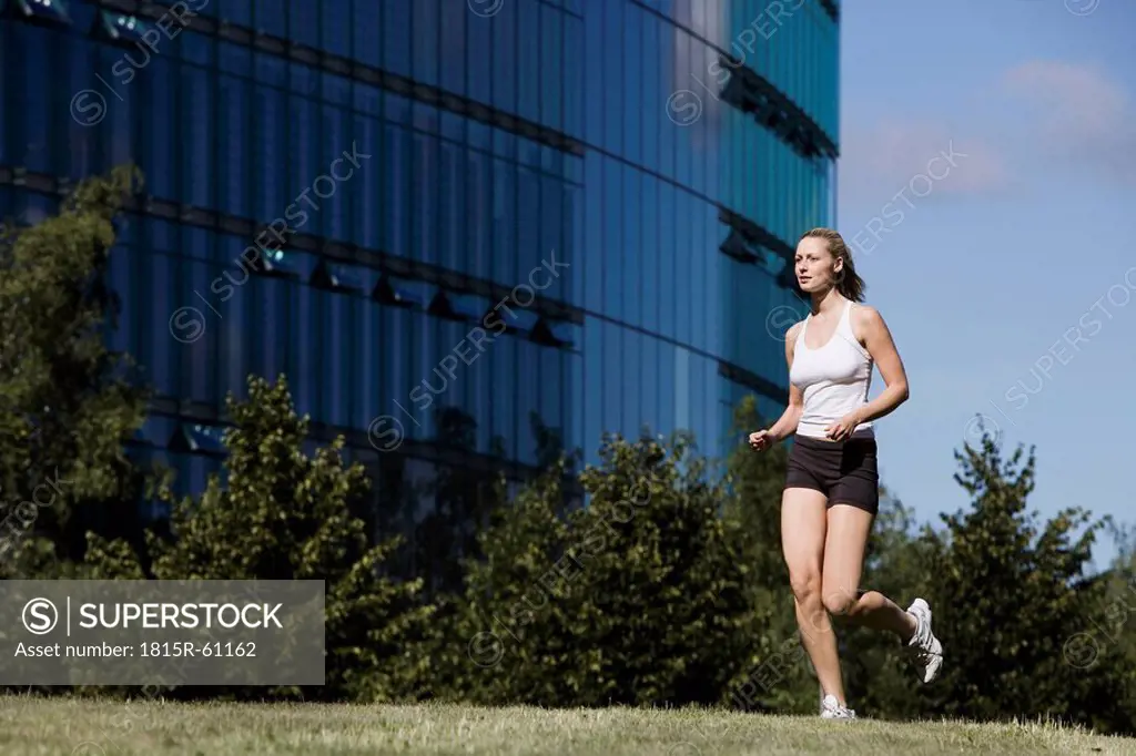 Germany, Berlin, Young woman jogging