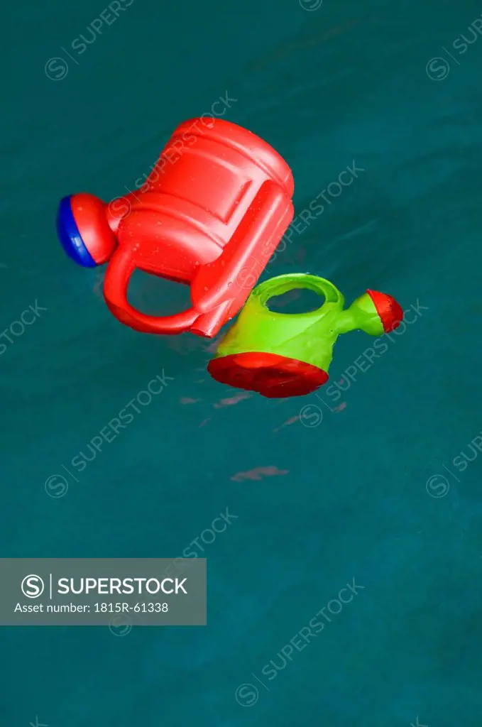 Germany, Baden_W¸rttemberg, Plastic watering can floating in pool
