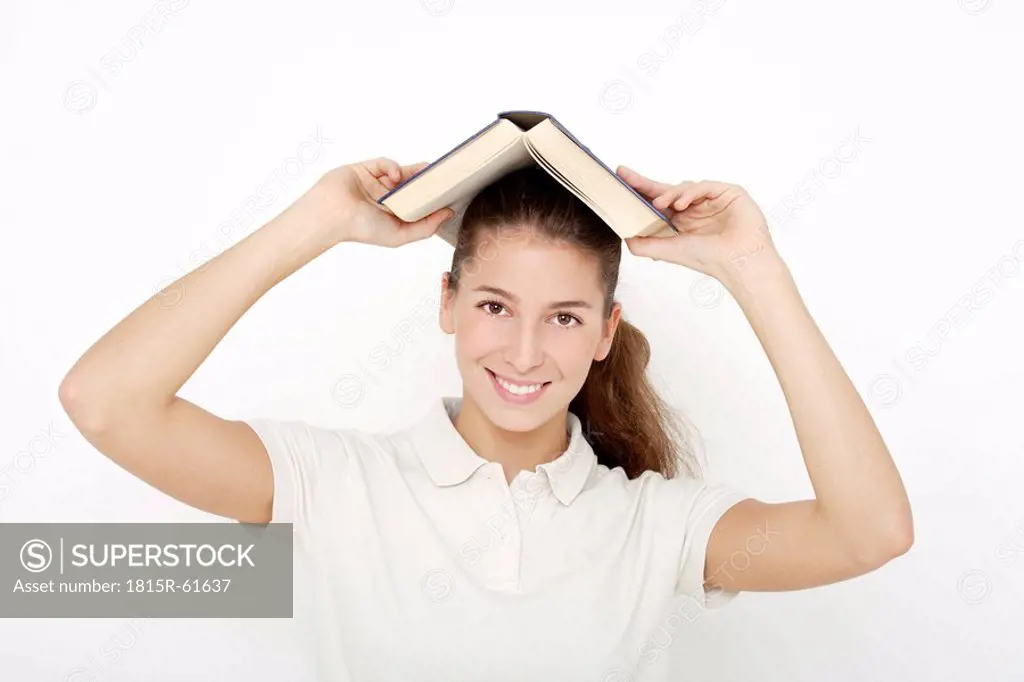 Young woman 16_17 holding book over head