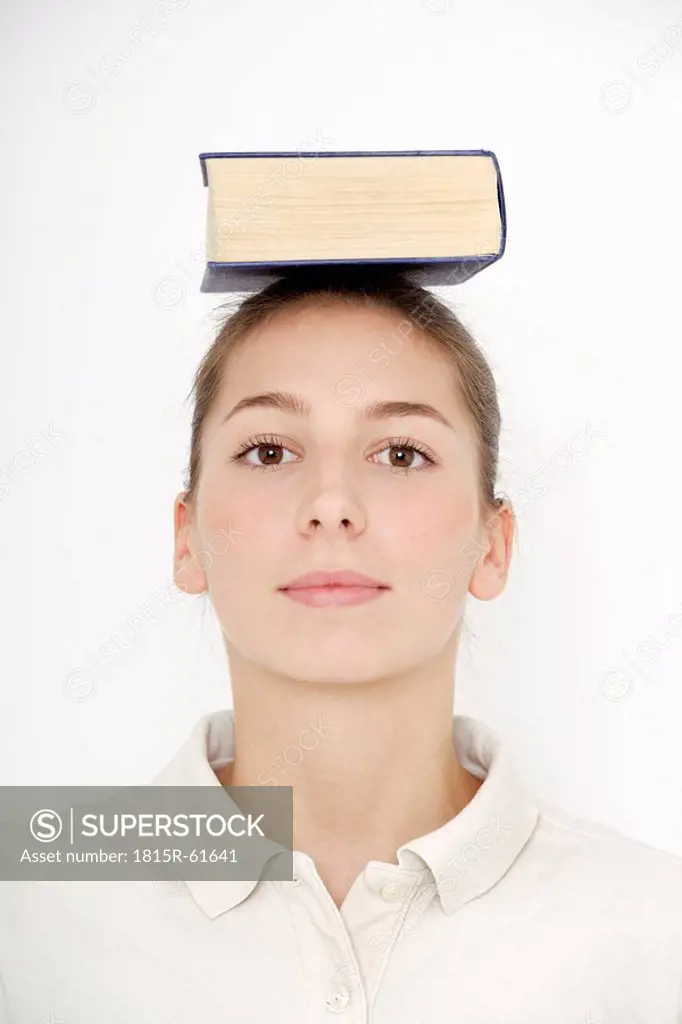 Young woman 16_17 balancing book on head