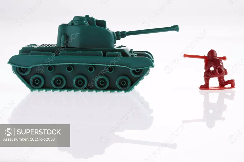 Toy army soldier and toy army tanks