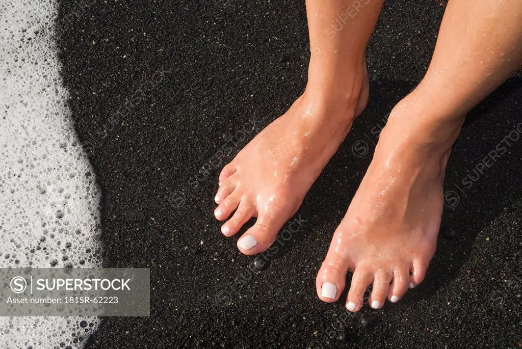 Spain, Lanzarote, Feet on lava sand, elevated view