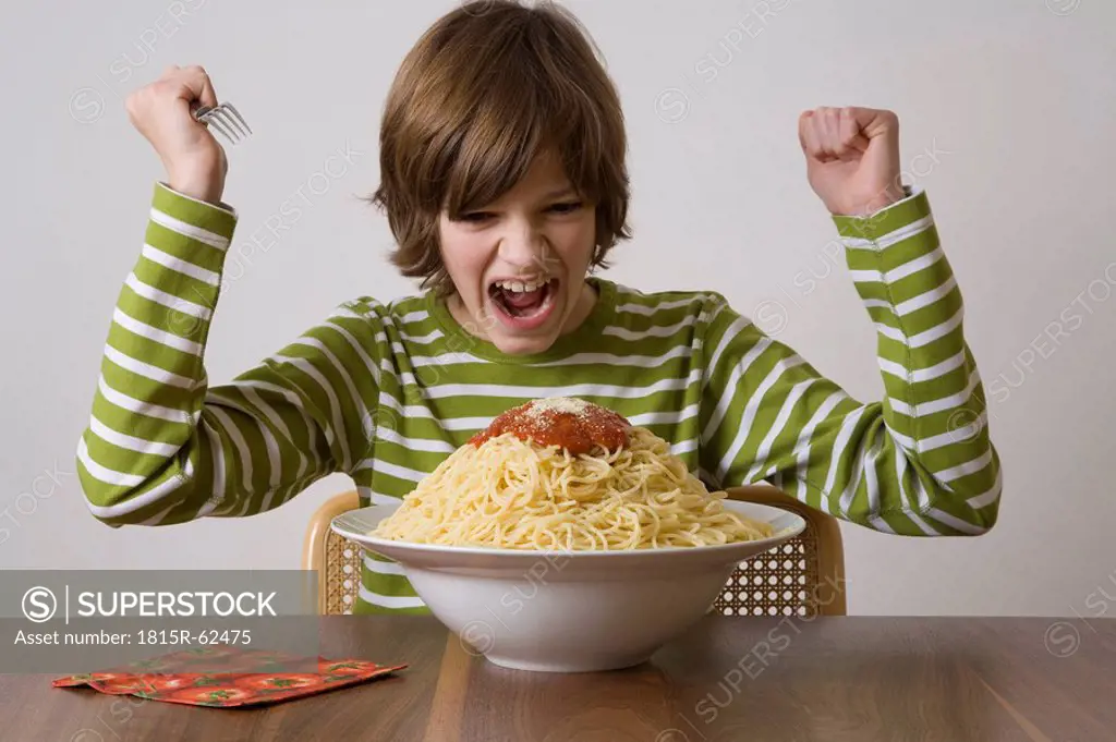 Germany, boy about to eat large plate of pasta