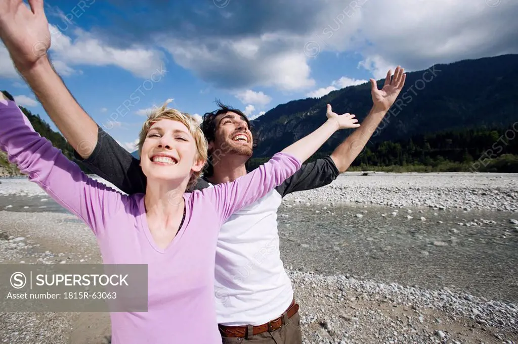 Germany, Bavaria, Tölzer Land, Young couple cheering