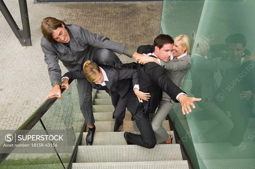 Germany, business people fighting on staircase