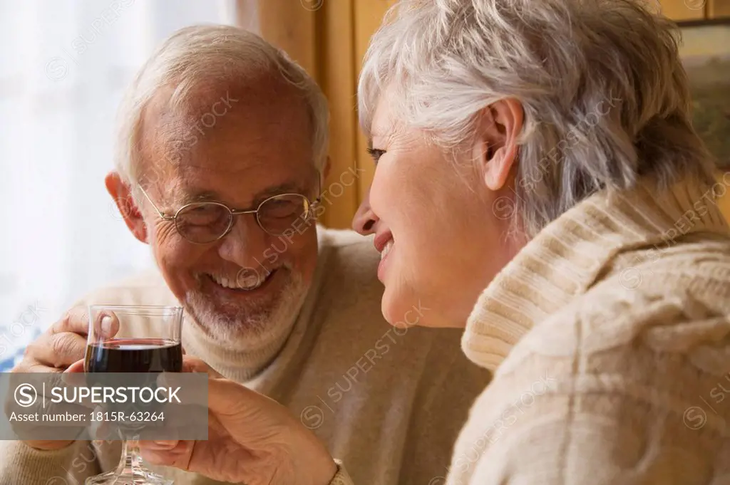 Senior couple holding wine glasses