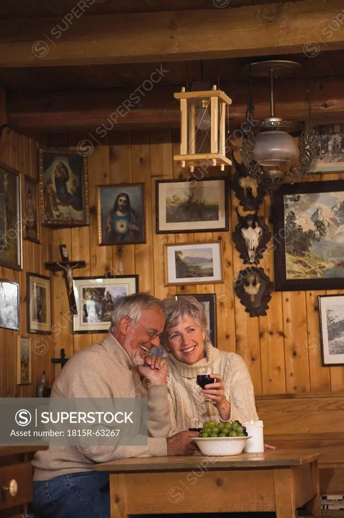 Senior couple sitting at table in Log Cabin