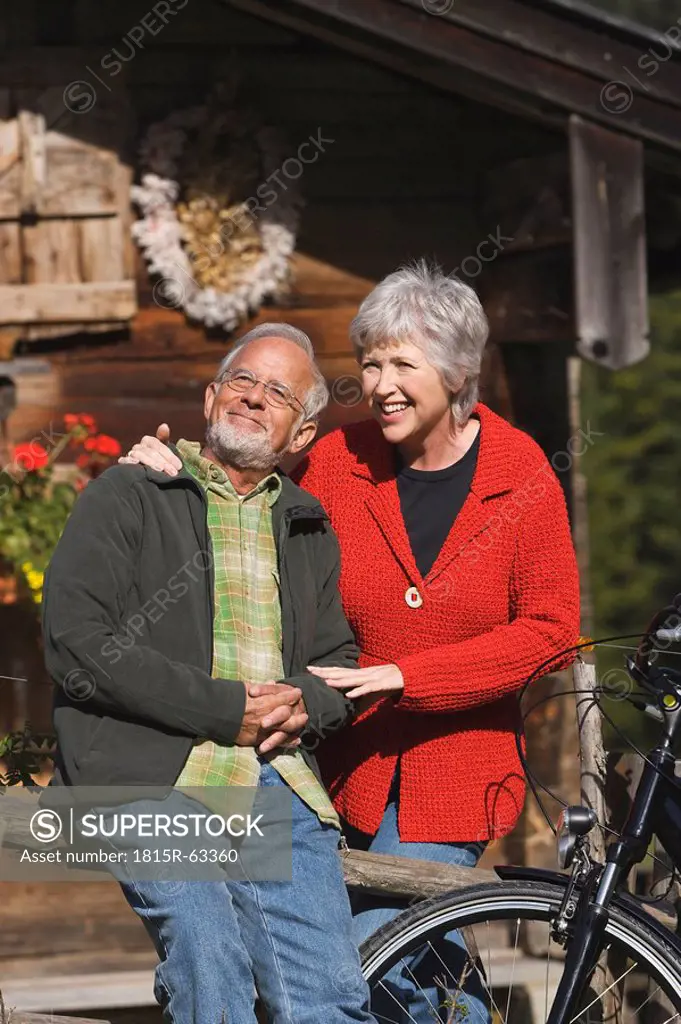 Austria, Karwendel, Senior couple in front of log cabin