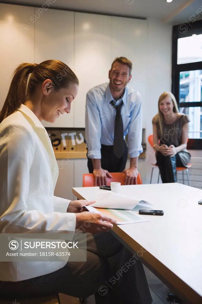 Business people in office, woman looking at documents