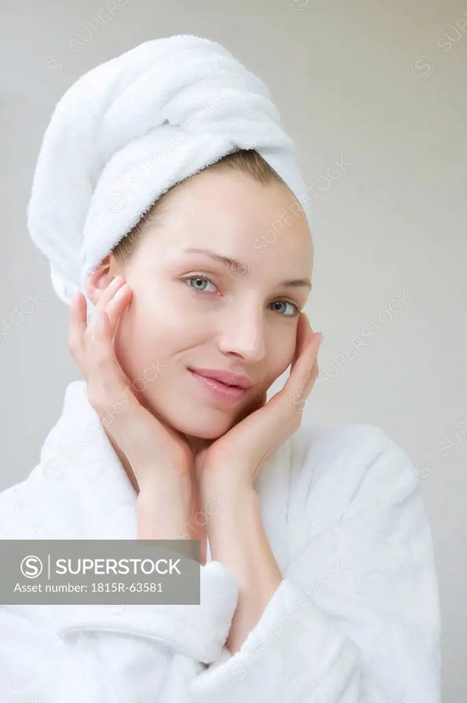 Young woman wearing towel on head, portrait