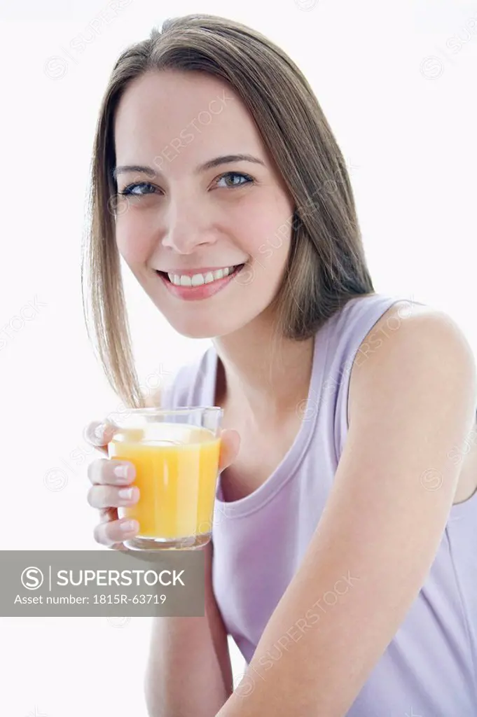 Young woman holding glass of juice, portrait
