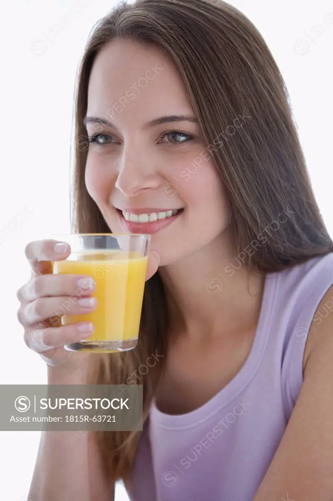 Young woman holding glass of juice, portrait, close_up