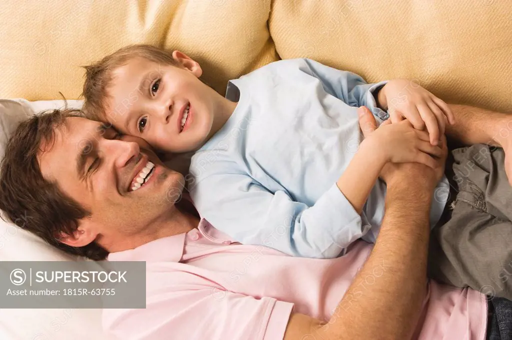 Father and son 4_5, relaxing on sofa, elevated view