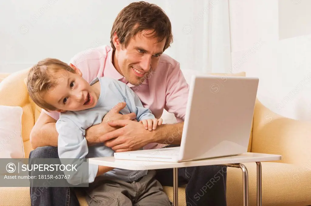 Father and son 4_5 using laptop