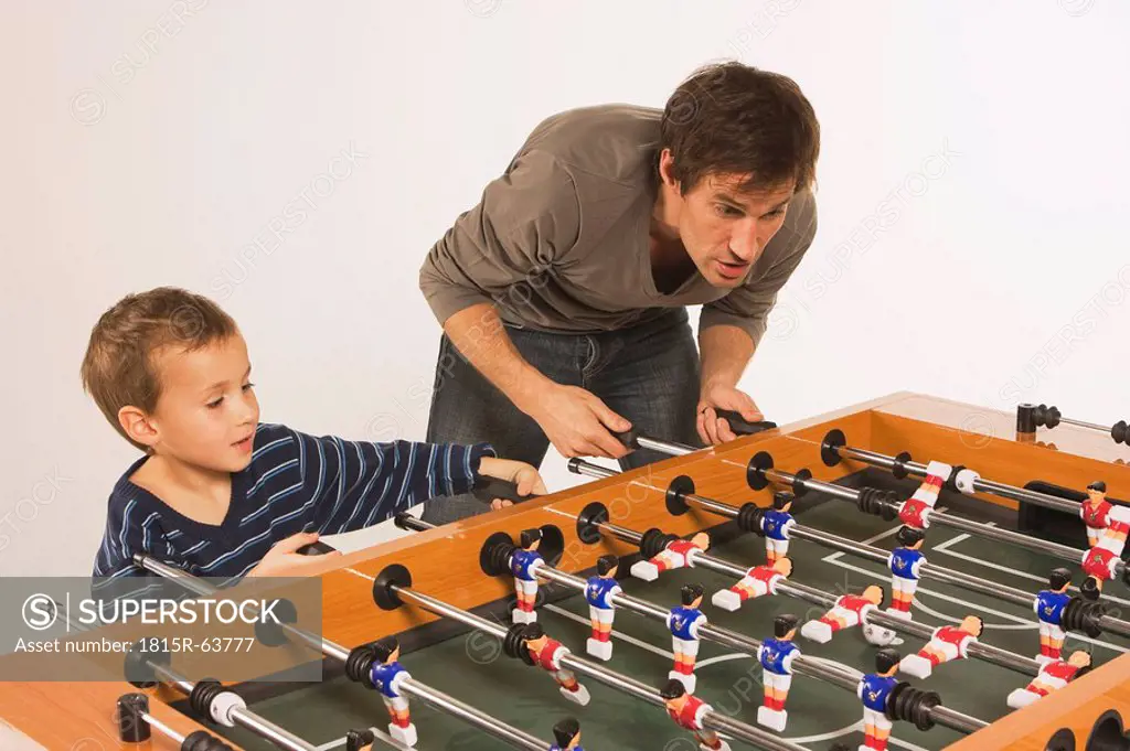 Father and son 4_5 playing tabletop soccer