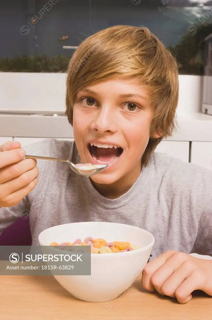 Teenage boy 13_14 having muesli for breakfast, portrait