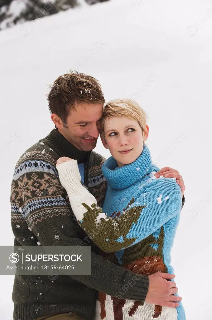 Young couple in winter clothes, embracing, portrait