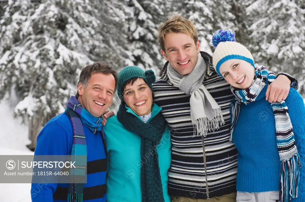 Italy, South Tyrol, Young people in winter clothes, arm in arm, portrait