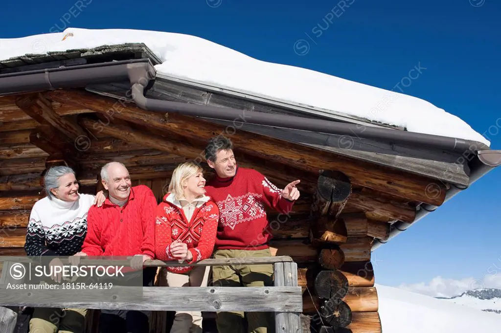 Italy, South Tyrol, Seiseralm, Log Cabin, Couple standing on balcony