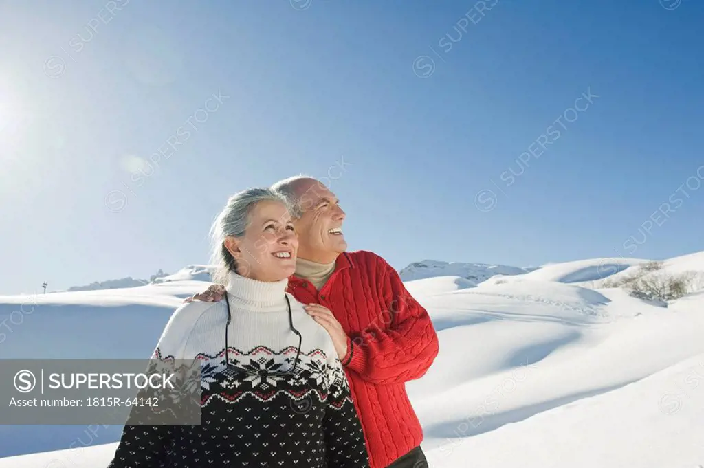 Italy, South Tyrol, Seiseralm, Senior couple in winterly landscape