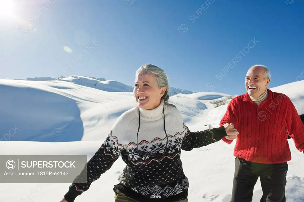 Italy, South Tyrol, Seiseralm, Senior couple in winter scenery