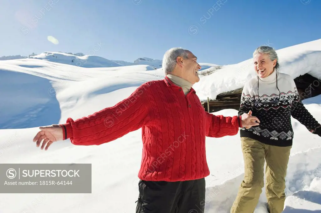 Italy, South Tyrol, Seiseralm, Senior couple in winter scenery
