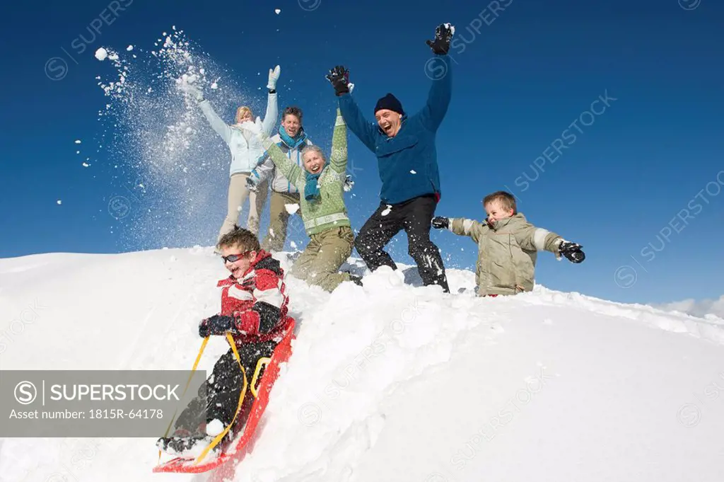 Italy, South Tyrol, Seiseralm, Family in snow, having fun