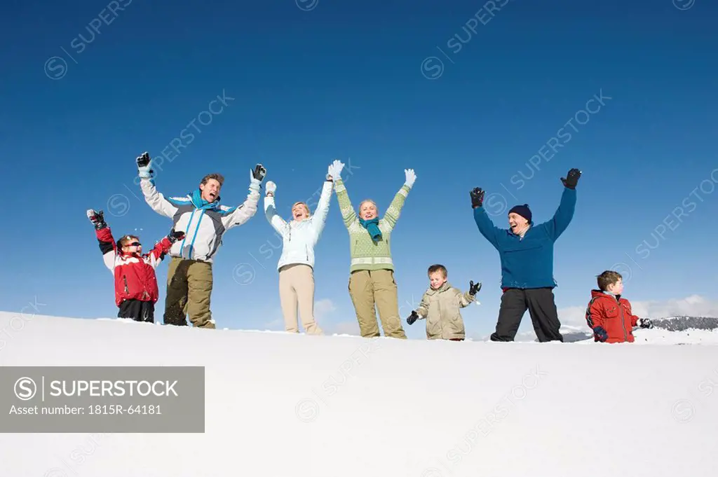 Italy, South Tyrol, Seiseralm, Family cheering in snow