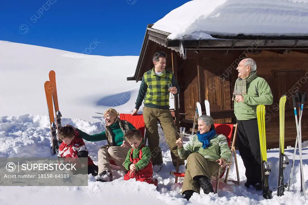 Italy, South Tyrol, Seiseralm, Family in front of log cabin