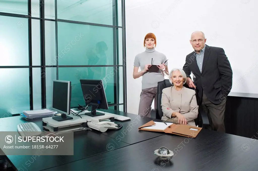 Germany, Munich, Business people in office, smiling, portrait