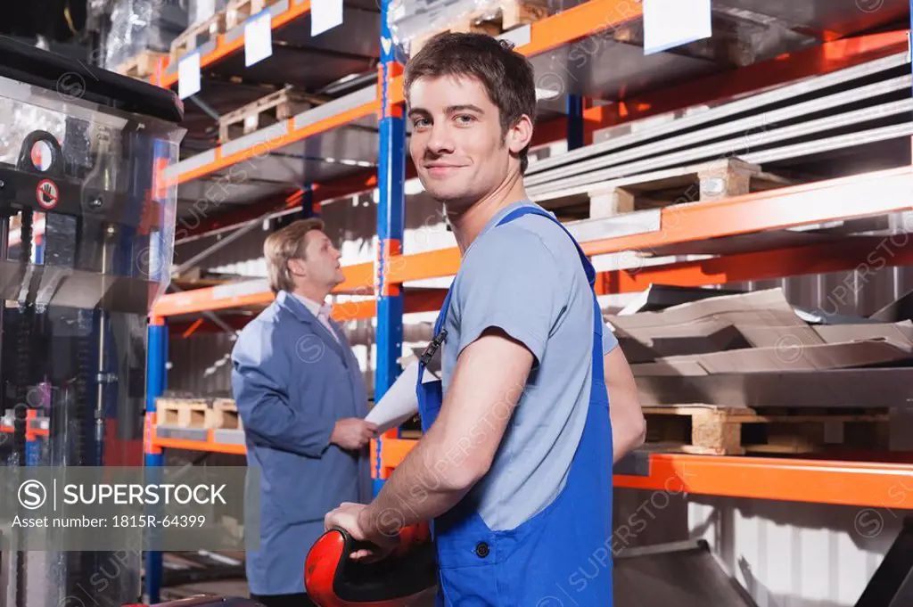 Germany, Neukirch, Apprentice and foreman in storeroom