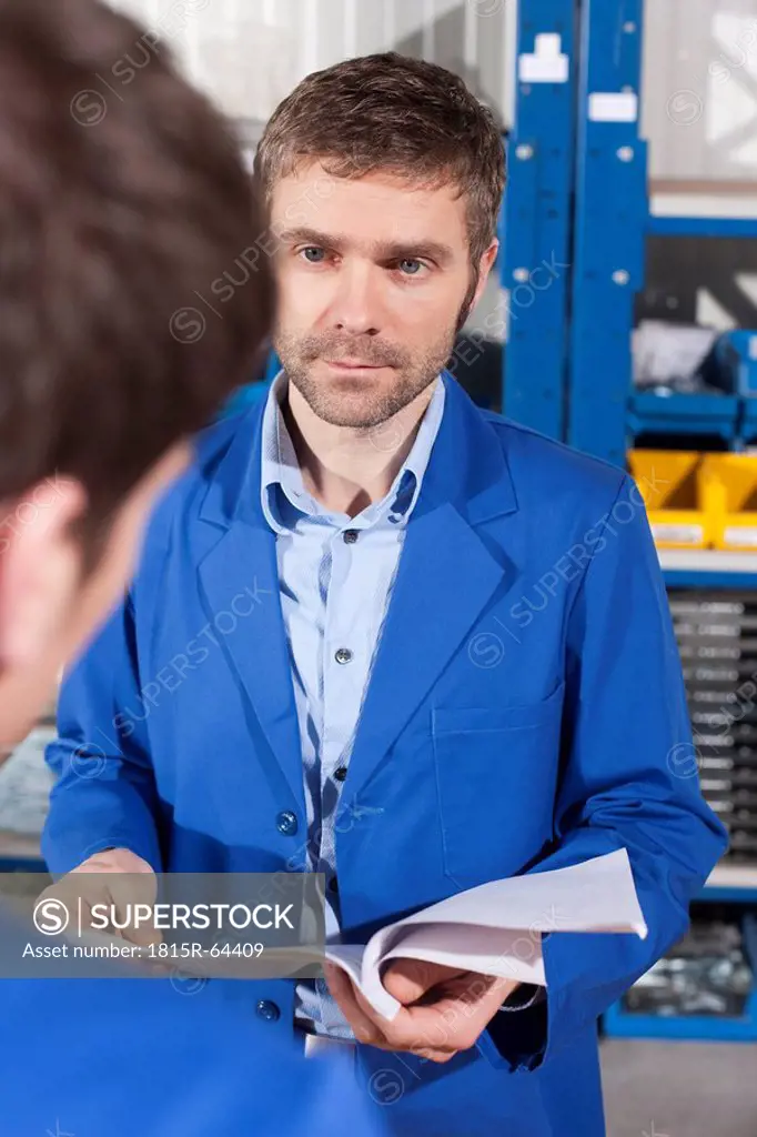 Germany, Neukirch, Apprentice and instructor, instructor holding documents