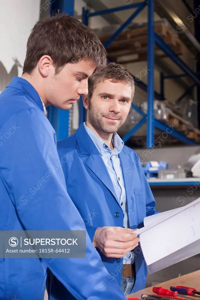 Germany, Neukirch, Apprentice and instructor, instructor holding documents