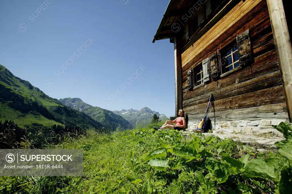 Woman resting at alp cottage