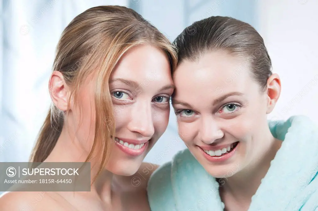 Germany, Bavaria, Munich, Two young women in spa, smiling, portrait