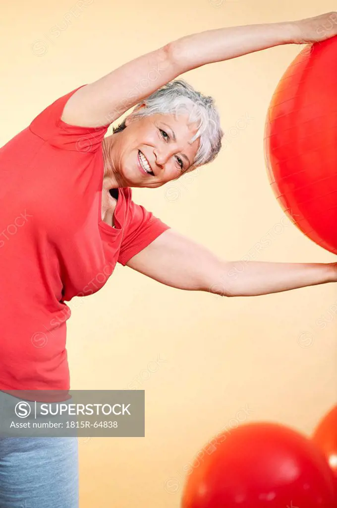 Senior woman practicing with gymnastic ball