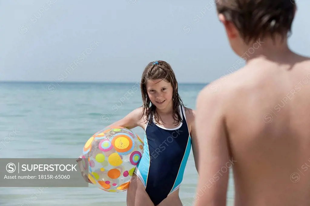 Spain, Mallorca, Children with beach ball on beach