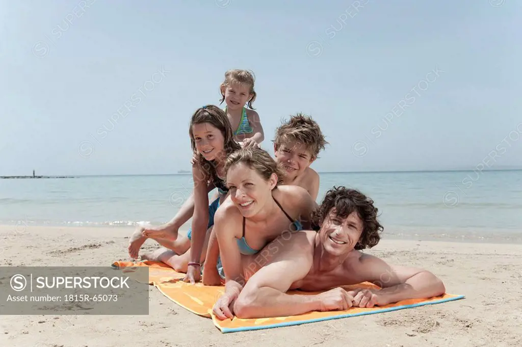 Spain, Mallorca, Family lying on beach