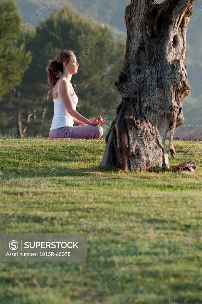 Spain, Mallorca, Woman exercising yoga, meditating