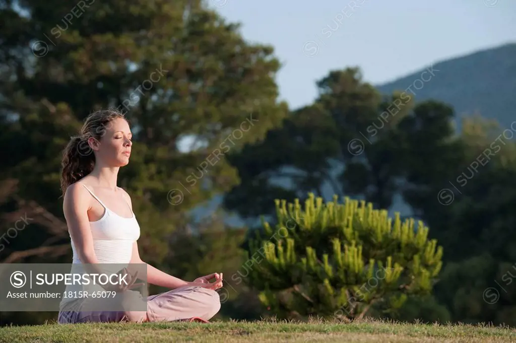 Spain, Mallorca, Woman exercising yoga, meditating
