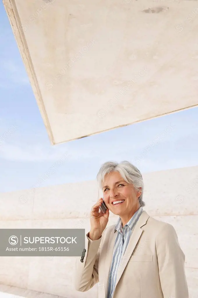 Spain, Mallorca, Senior Businesswoman using mobile phone