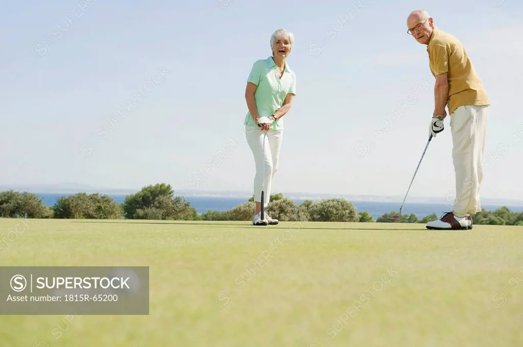 Spain, Mallorca, Senior couple playing golf